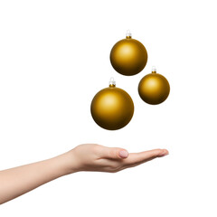 Three golden baubles or Christmas balls levitating over woman's hand. Hand palm up.