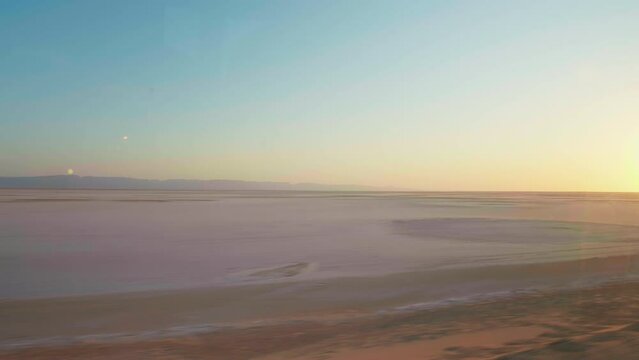 Moving shot of dry lake Chott el Djerid in Tunisia in Africa. The remains of dried salted lake because of severe drought in desert.
