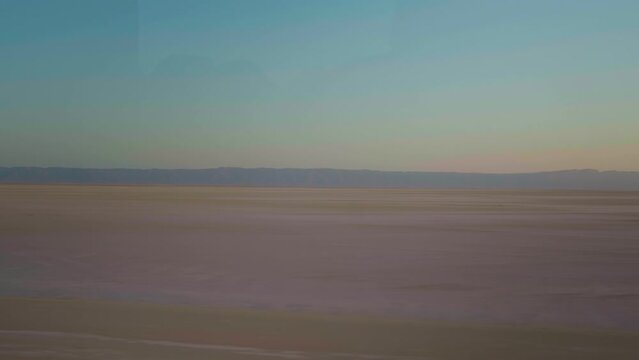 Moving shot of dry lake Chott el Djerid in Tunisia in Africa. The remains of dried salted lake because of severe drought in desert