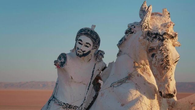 Horse and knight statue at the bottom of early existed Chott el Djerid salted lake. Statues in deserted parts of african continent.