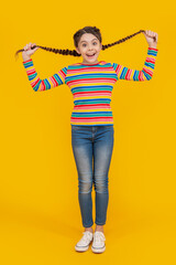 photo of amazed teen braided girl. childhood studio shot of teen braided girl. teen braided girl