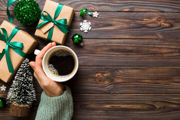 Woman holding cup of coffee. Woman hands holding a mug with hot coffee. Winter and Christmas time concept