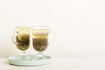 Healthy breakfast or morning with chia seeds and lemon on table background, vegetarian food, diet and health concept. Chia pudding with lemon