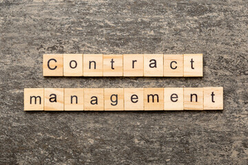 contract management word written on wood block. contract management text on table, concept