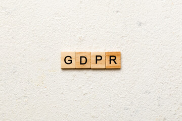 GDPR word written on wood block. general data protection regulation text on cement table for your desing, concept