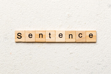 Sentence word written on wood block. Sentence text on table, concept