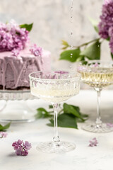 mousse cake blueberry tart. bouquet of purple blooming lilacs, French cuisine, postcard, background