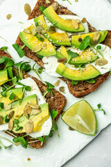 avocado toasts with cheese, pumpkin, nut and sesame. Healthy fats, clean eating for weight loss