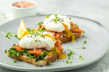 poached egg on toast with salmon, lettuce salad, Delicious breakfast or snack, Clean eating, dieting, vegan food concept. top view