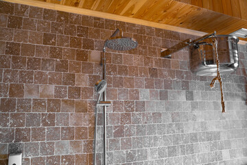 rain shower in the bathroom. Silver shower in the bathroom with beige tiles. Beautiful shower. Water treatments. A watering can for the shower.