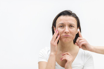 Fototapeta premium Photo of positive woman holding a cream in hand on white background.