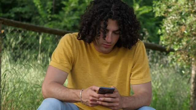 comminication, globalization -man types on mobile phone  to write a message