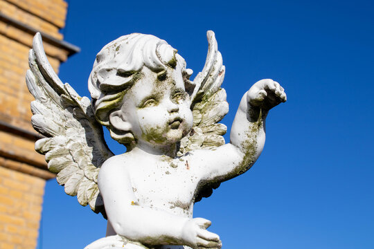 Guardian angel statue in light as a symbol of strength, truth and faith. Horizontal image