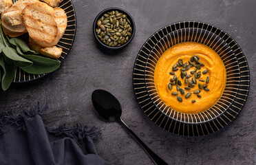 Food photography of pumpkin soup, cream,  toast, seeds, vegan, sage