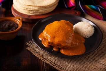 Encacahuatado. Mexican mole made from peanuts, dried chilies, sesame seeds, tomatoes and other spices. It is served bathing pieces of beef, pork or chicken or in Enmoladas.