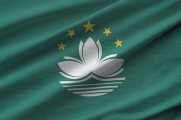 Macau flag with big folds waving close up under the studio light indoors. The official symbols and...