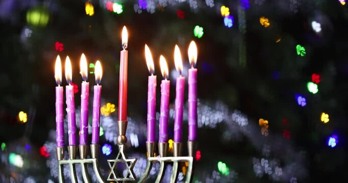 Celebration Hanukkah Judaism tradition holiday symbols by lighting hanukkiah candles on menorah