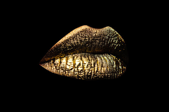 Luxury glamour art mouth. Golden lips isolated on black background. Clipping path gild lips.