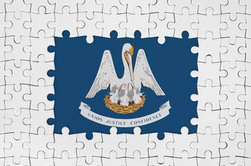 Louisiana US state flag in frame of white puzzle pieces with missing central part