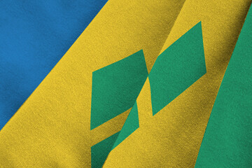 Saint Vincent and the Grenadines flag with big folds waving close up under the studio light...