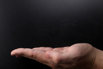 Fototapeta na wymiar Holding hand concept with black background