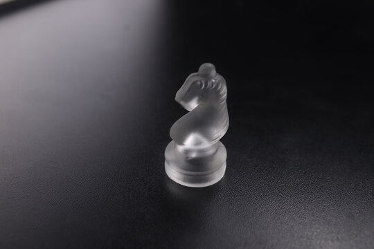 glass knight pieces on black bacground. chess concept.