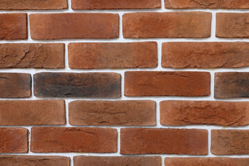 Decorative bricks on repaired wall as background, closeup