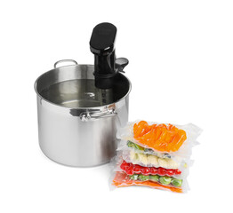 Thermal immersion circulator in pot and vacuum packs with different food products on white...
