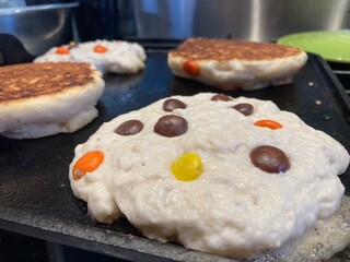 Reese's Pieces pancakes on the griddle