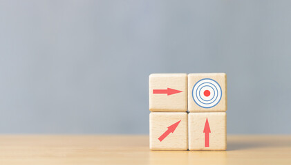 wooden block with arrow pointing target icon business development strategy Progress for the success...