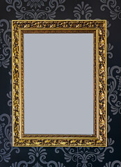 Blank gold frame on wallpaper patern