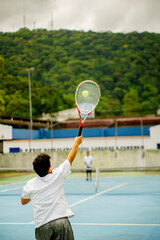 kids playing indoor tennis at a sports club during the summer professionally in a championship