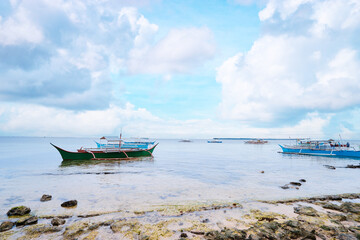 Beach with traditional fishing boats, Philippines.