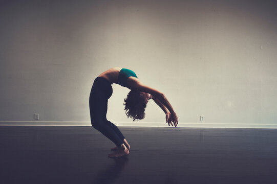 P{photographs of advanced yoga postures demonstrated by a professional teacher in studio. 