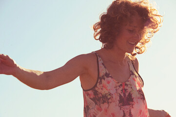 Joyful woman playing yoga and with the wind in her hair. 