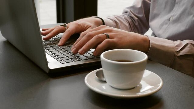 caffeine, stimulant-student writes the thesis on the pc with a cup of coffee