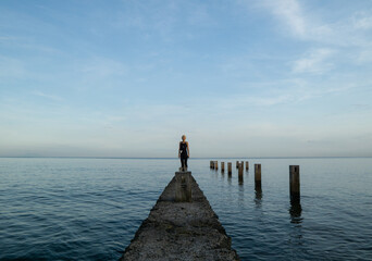 A blonde woman walking and taking pictures around Lovina beach, Bali, Indonesia.