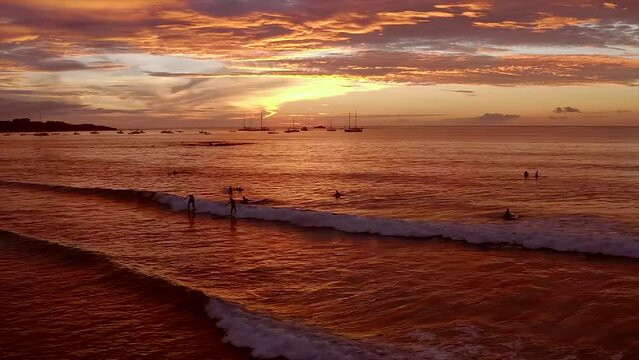 A aerial view of a sunset surf session in Coast Rica.