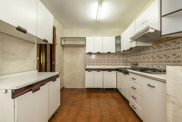 old kitchen with white wood-edged cabinets, white wood countertops and vintage tiles