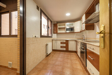 kitchen with white and dark wood cabinets, beige wood countertops and tile style tiles