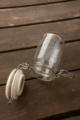 Empty glass jar with vacuum seal on acacia wood planks