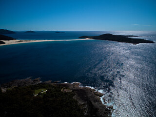 Drone photo of Fingal Bay and the spit leading to Shark Island on a bright sunny day