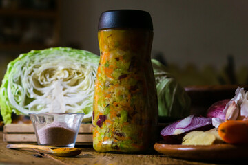 Sauerkraut still life with ingredients and vegetables on a table. No people. 