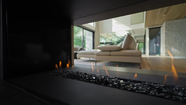 3-sided Modern Gas Fireplace Open on Three Sides in Luxury House Interior - side dolly in slow motion