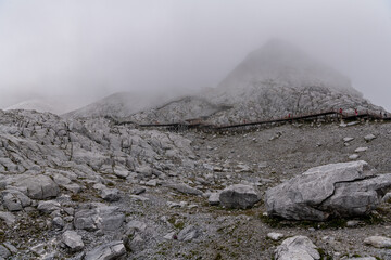 Lijiang Jade dragon snow mountain of Yunnan, China in fog, view from the footsteps