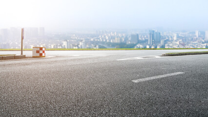 Background of asphalt pavement and urban architectural landscape skyline