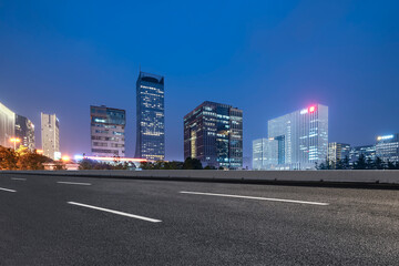 Fototapeta na wymiar Background of asphalt pavement and urban architectural landscape skyline