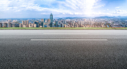 Background of asphalt pavement and urban architectural landscape skyline