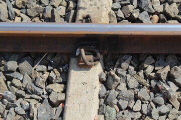 Railway lines with track ballast. Train tracks underlay, rails and crushed stones. Industrial landscape. Railway junction.