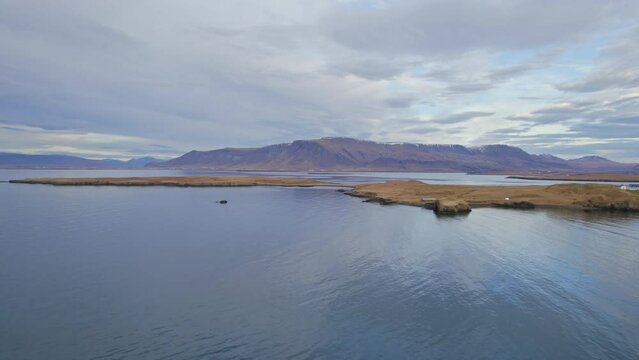 Small Icelandic Island In Atlantic Ocean Arctic Circle With Beautiful Mountains In The Background. 4K Aerial Drone Footage.